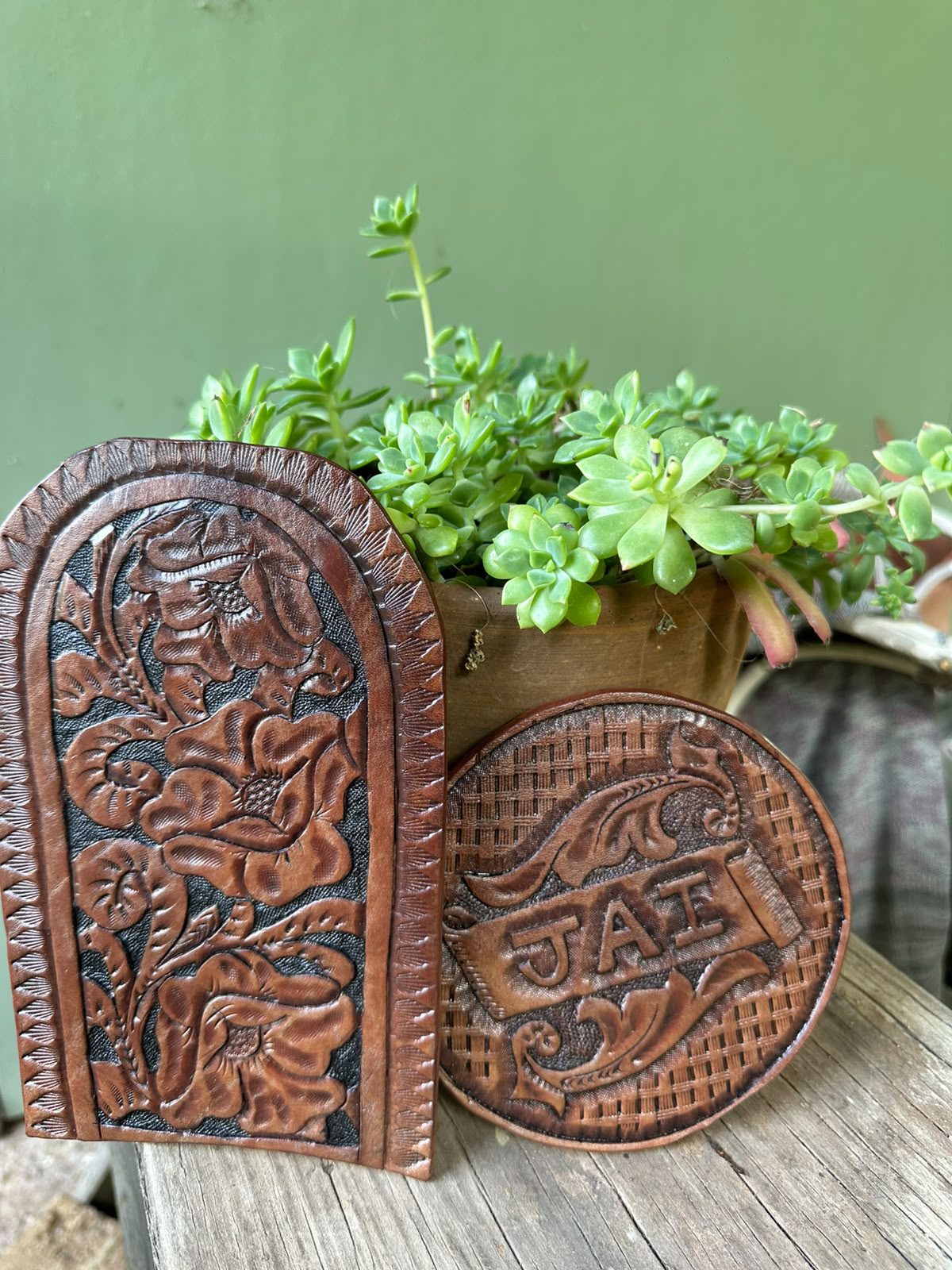 Hand-tooled leather panels stood against a wooden bench.